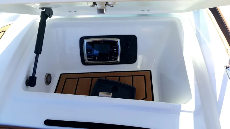 Slide: The Image of A control area with a modern panel and wood trim in a Nautique boat. - 8