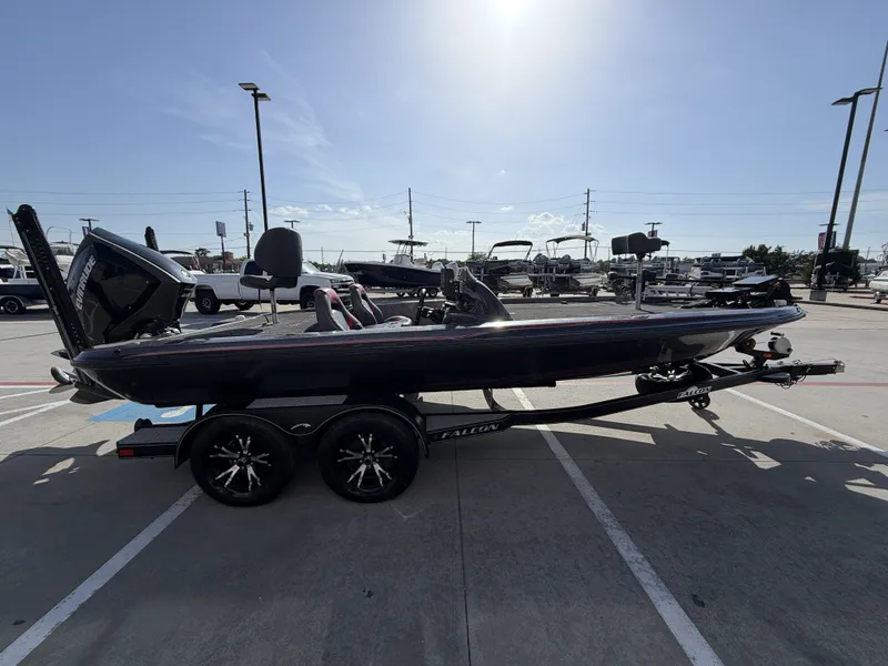 Slide: The Image of A 2018 Falcon F205 sits on a trailer in a parking lot. It's a sleek, modern boat. - 7