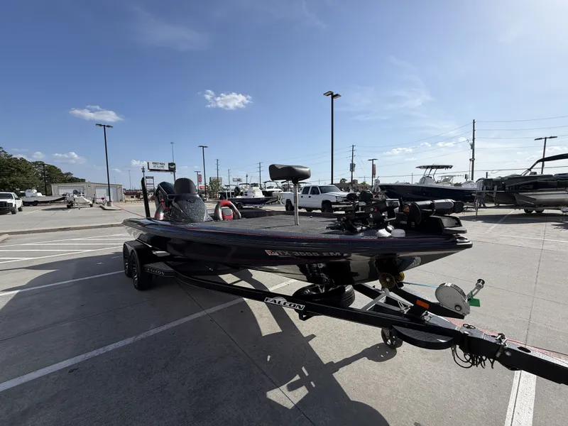 Slide: The Image of A black Falcon F205 boat from 2018 is on a trailer in a parking lot. - 6