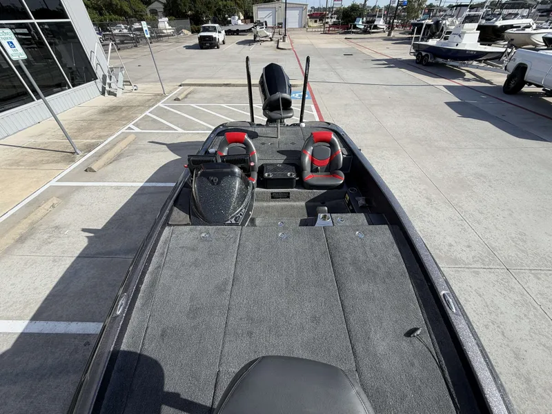 Slide: The Image of The image shows a 2018 Falcon F205 boat in a parking lot. It features two seats and a gray deck. - 33