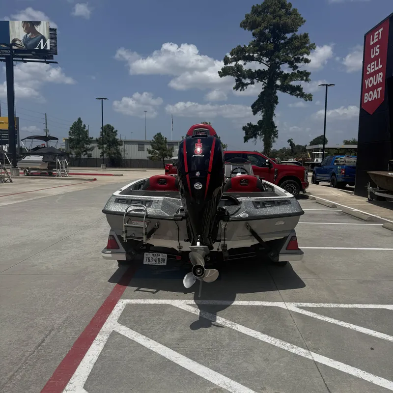 Slide: The Image of A 2019 Ranger Z518 boat is parked in a lot. It features an outboard motor. - 9