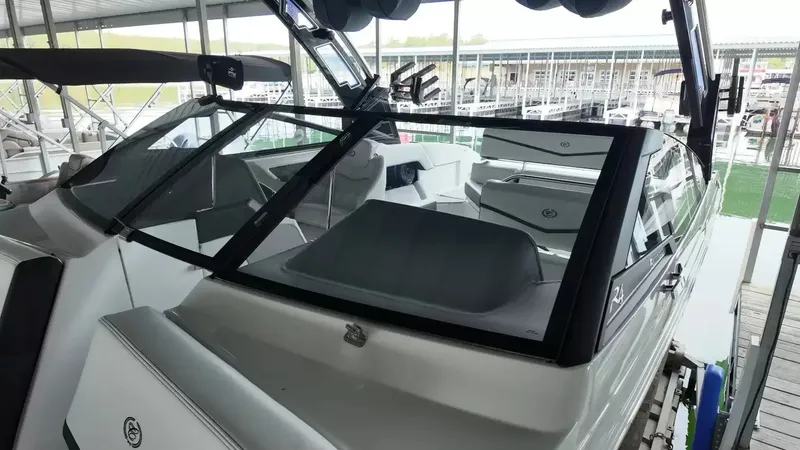 Slide: The Image of The image shows a modern 2026 Cobalt R4 Surf boat docked in a marina. - 30