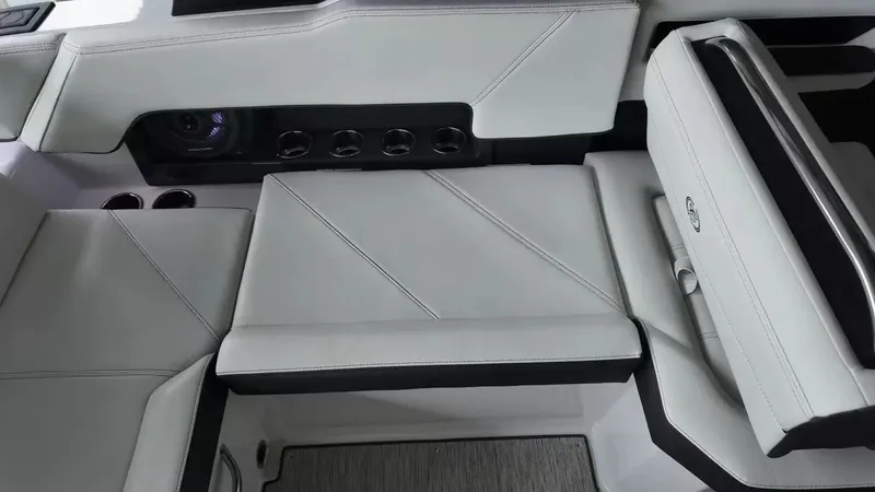 Slide: The Image of The image shows the luxurious interior of a Cobalt R4 Surf boat with sleek white upholstery. - 35