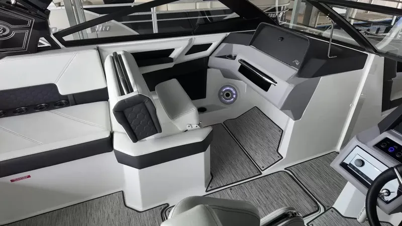 Slide: The Image of The image shows the interior of a 2026 Cobalt R4 Surf boat with modern seating and controls. - 32