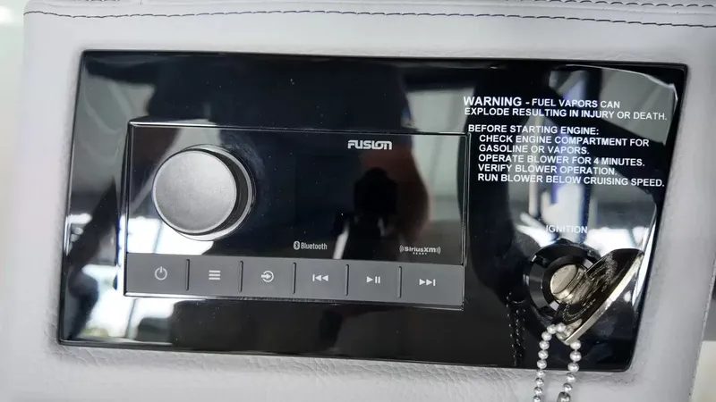 Slide: The Image of Close-up of a Fusion audio system with warning labels on a Cobalt boat. - 17