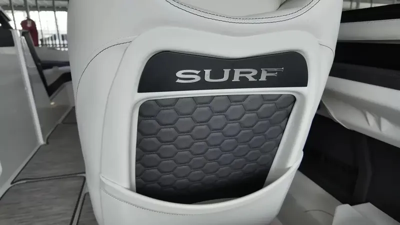 Slide: The Image of Close-up of a seat in the Cobalt R4 Surf boat with "SURF" lettering and hexagonal pattern. - 27
