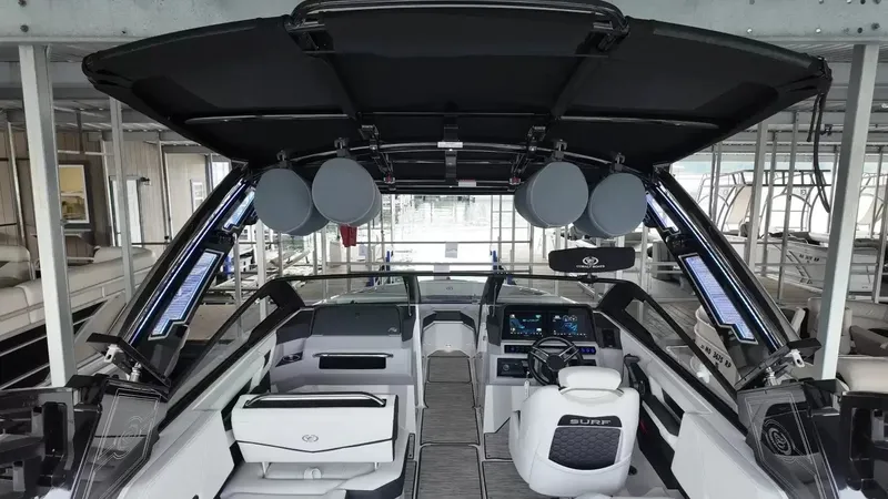 Slide: The Image of The image shows the interior of a 2026 Cobalt R4 Surf boat with modern seating and electronics. - 38