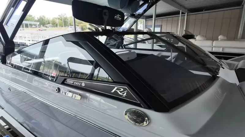 Slide: The Image of The image shows a modern 2026 Cobalt R4 Surf boat in a covered area. - 14
