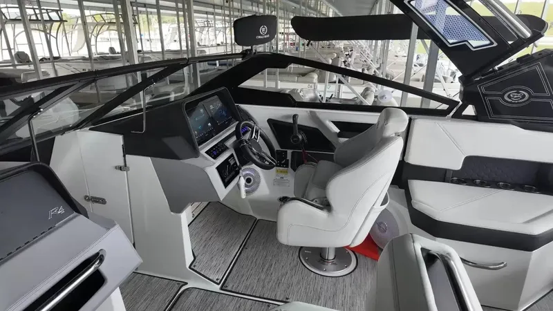 Slide: The Image of The image shows the cockpit of a 2026 Cobalt R4 Surf boat with modern instruments and a comfortable seat. - 29