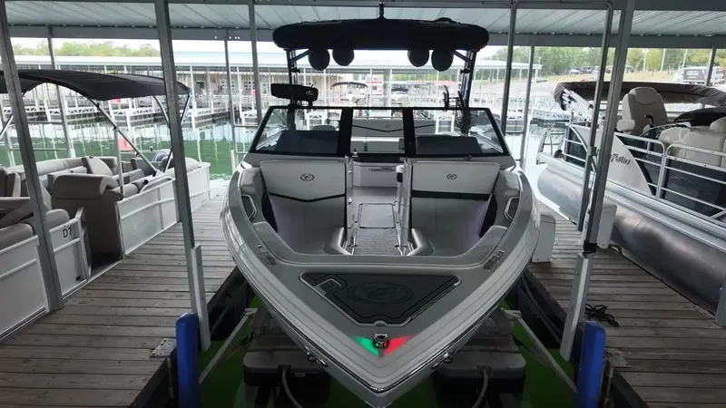 The Image of The image shows a 2026 Cobalt R4 Surf boat in a covered dock. - 3