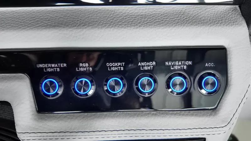 Slide: The Image of Close-up of a control panel area with six illuminated buttons for various boat lights. - 20