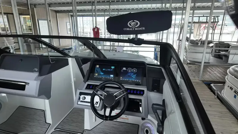 Slide: The Image of The image shows the cockpit of a 2026 Cobalt R4 Surf boat with modern instruments. - 21