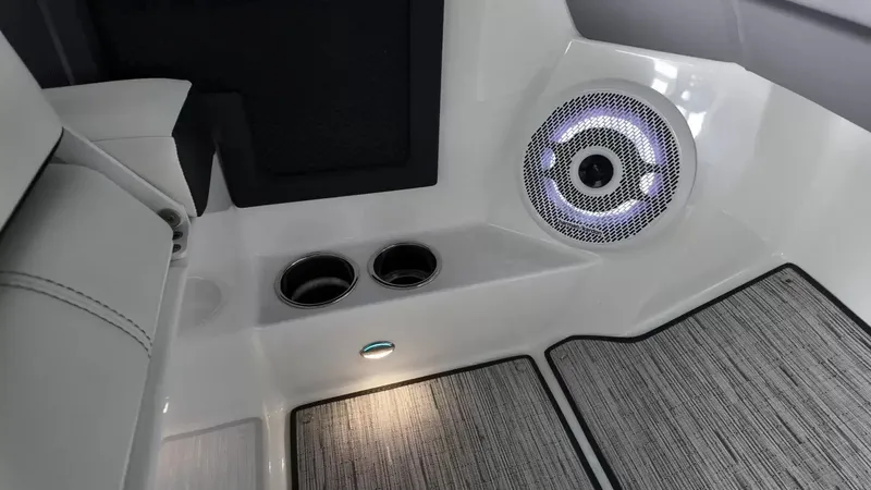 Slide: The Image of The image shows the interior of a Cobalt R4 Surf boat with a speaker and cup holders. - 34