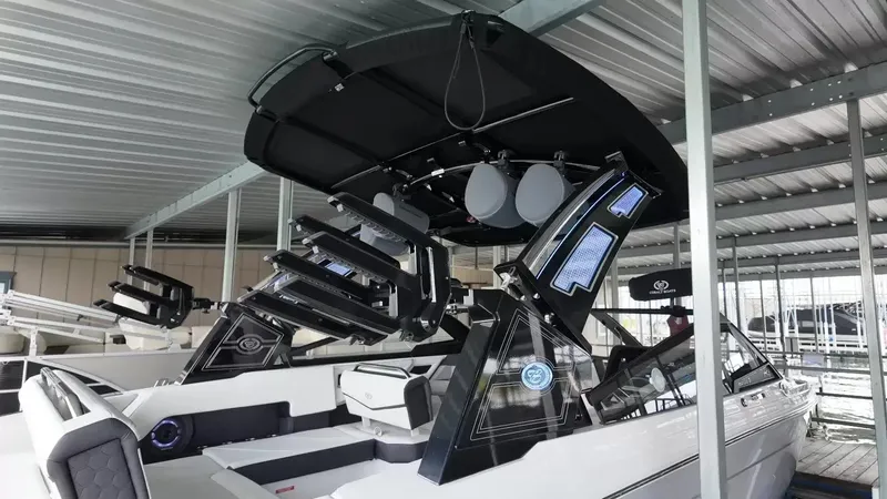 Slide: The Image of The image shows a modern 2026 Cobalt R4 Surf boat in a covered dock. - 42