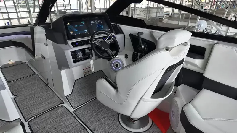 Slide: The Image of The image shows the cockpit of a 2026 Cobalt R4 Surf boat with modern instruments and white seats. - 15