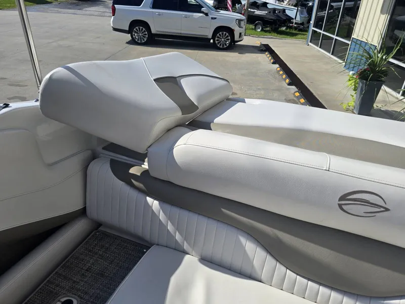 Slide: The Image of The image shows the interior of a 2016 Crownline 21 SS boat with white upholstery. - 12