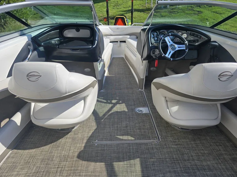 Slide: The Image of The image shows the cockpit of a 2016 Crownline 21 SS boat with two swivel seats and a modern dashboard. - 13