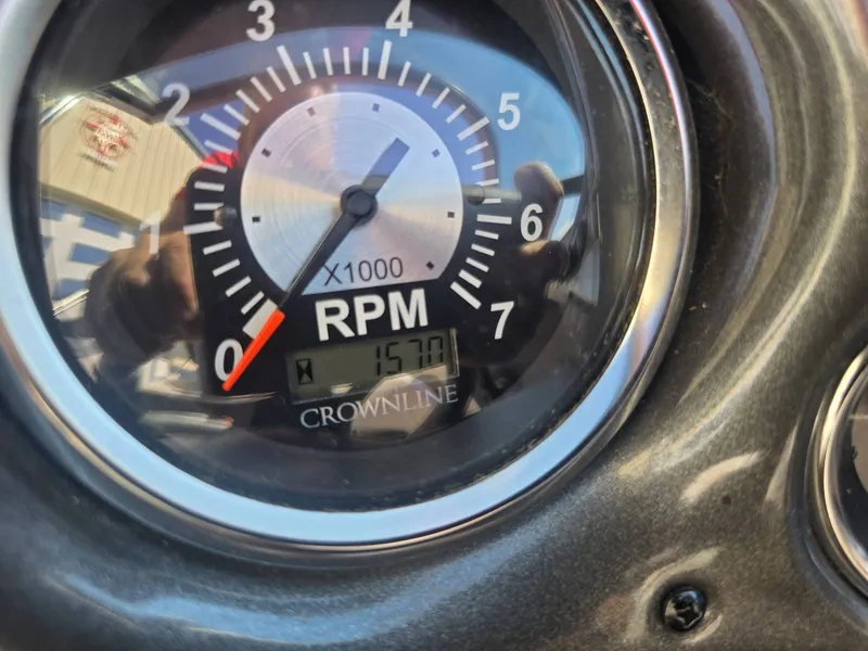 Slide: The Image of Close-up of a tachometer showing 157.7 hours on a Crownline boat. - 29
