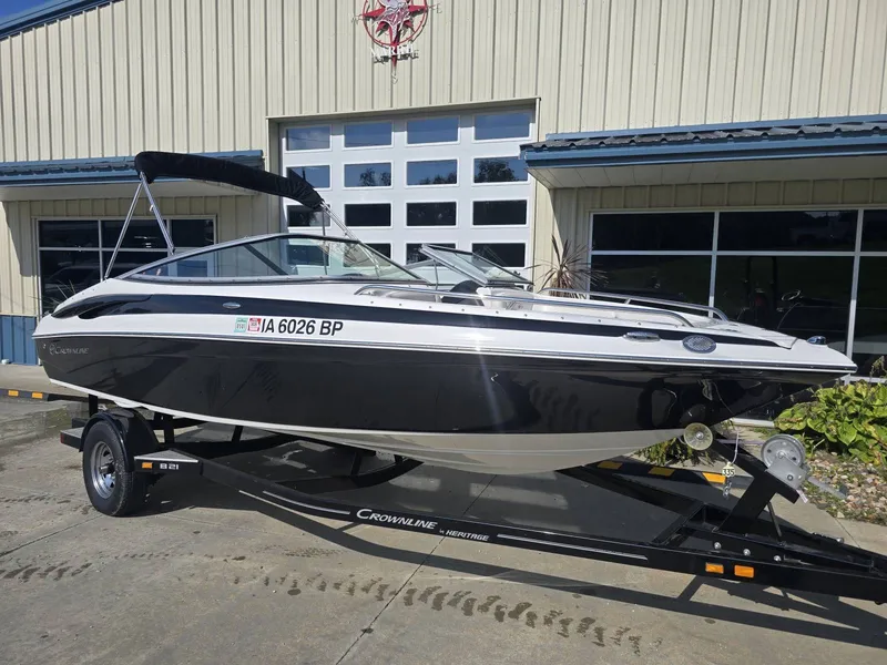 Slide: The Image of A black 2016 Crownline 21 SS boat on a trailer in front of a building. - 4