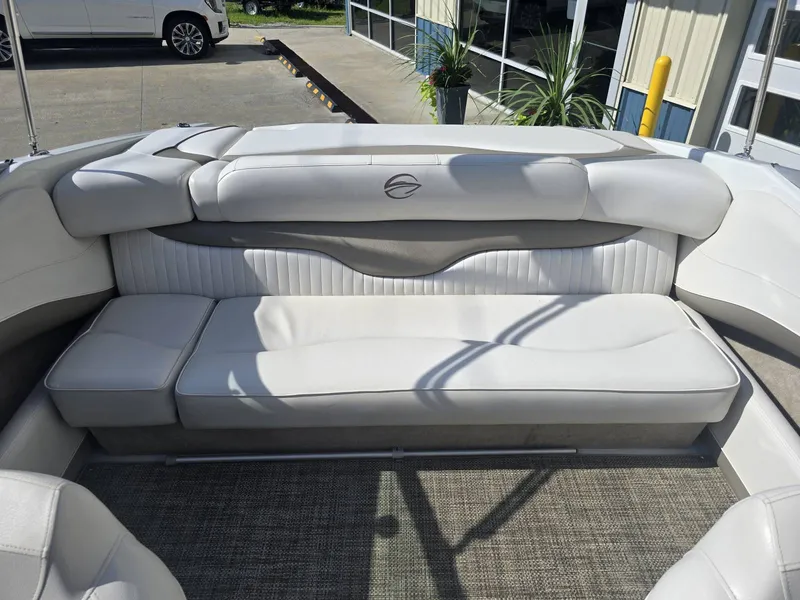 Slide: The Image of The image shows the white upholstered rear seating of a 2016 Crownline 21 SS boat. - 10