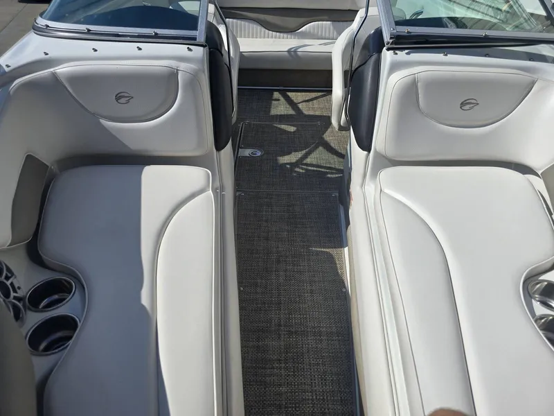 Slide: The Image of The image shows the interior of a 2016 Crownline 21 SS boat with white seating. - 24
