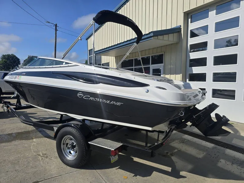 Slide: The Image of A 2016 Crownline 21 SS boat on a trailer in front of a building. - 3