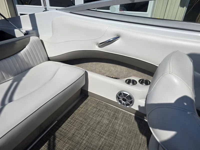 Slide: The Image of Interior of a 2016 Crownline 21 SS boat with white seating and a speaker. - 27
