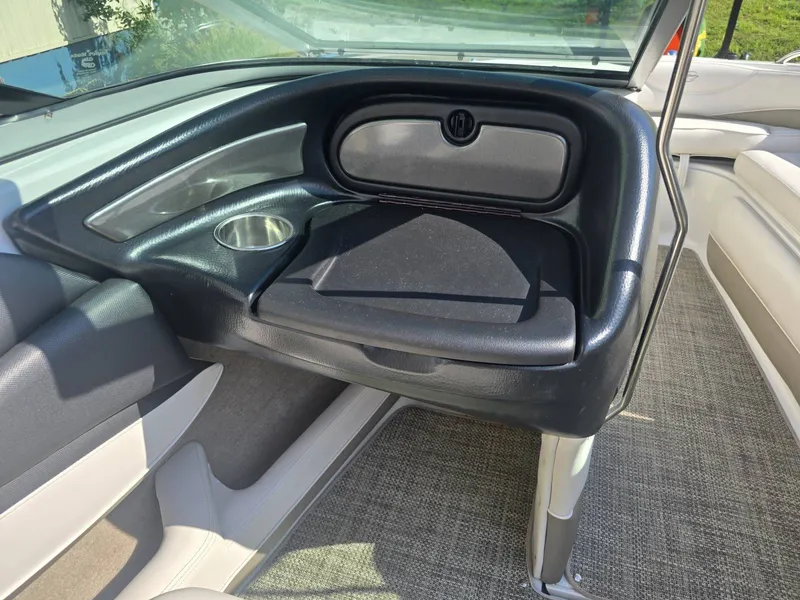 Slide: The Image of Interior of a 2016 Crownline 21 SS boat with cushioned seating and a cup holder. - 17