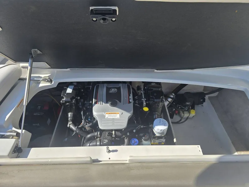 Slide: The Image of The engine compartment of a 2016 Crownline 21 SS boat is visible, featuring a well-maintained engine. - 28