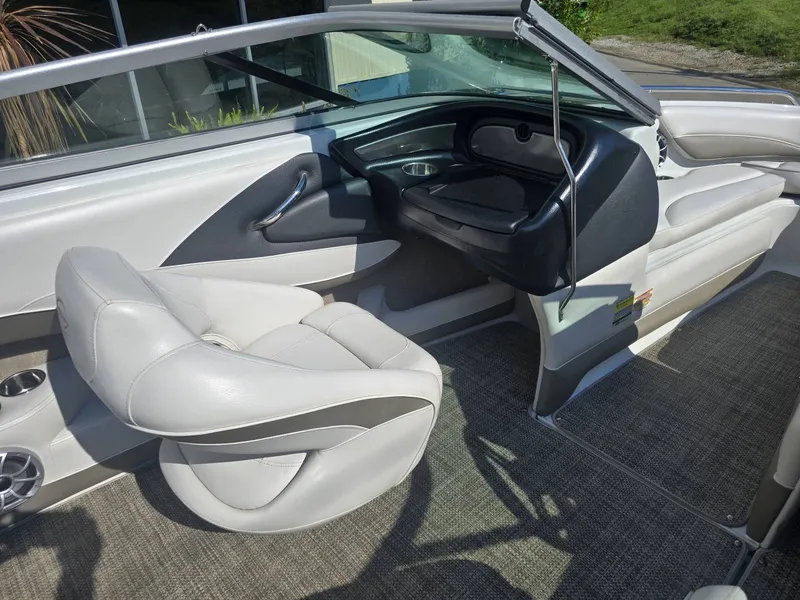 Slide: The Image of The image shows the cockpit of a 2016 Crownline 21 SS boat with white leather seats. - 16