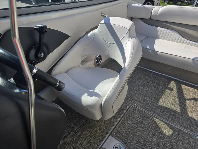 Slide: The Image of Interior of a 2016 Crownline 21 SS boat with white seating and carpeted flooring. - 19