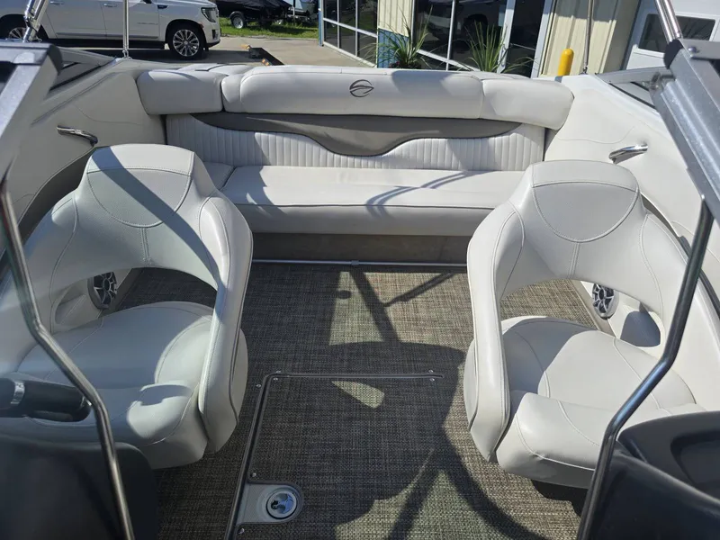Slide: The Image of Interior of a 2016 Crownline 21 SS boat with white seating and carpeted floor. - 25