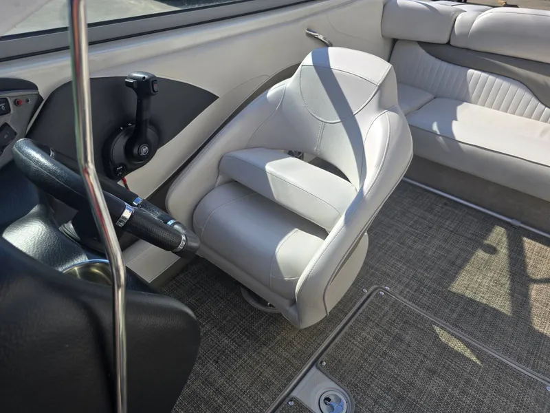Slide: The Image of Interior of a 2016 Crownline 21 SS with beige upholstered seating and carpeted flooring. - 20