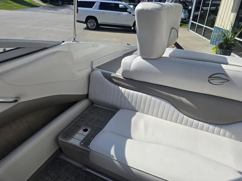 Slide: The Image of The image shows the interior of a 2016 Crownline 21 SS boat with white upholstery. - 11