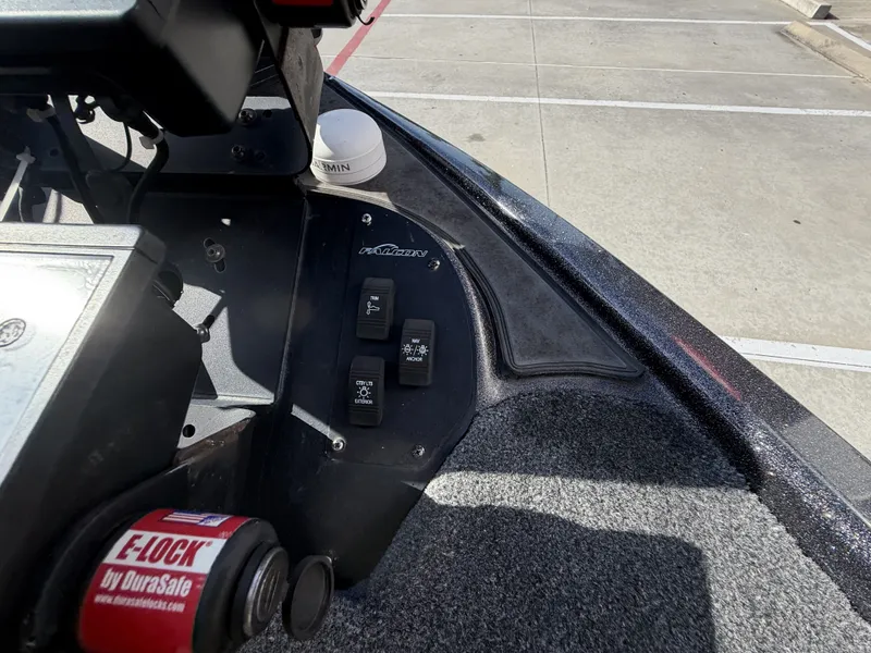 Slide: The Image of Close-up of the control area on a 2018 Falcon F205 boat with switches and a cup holder. - 32