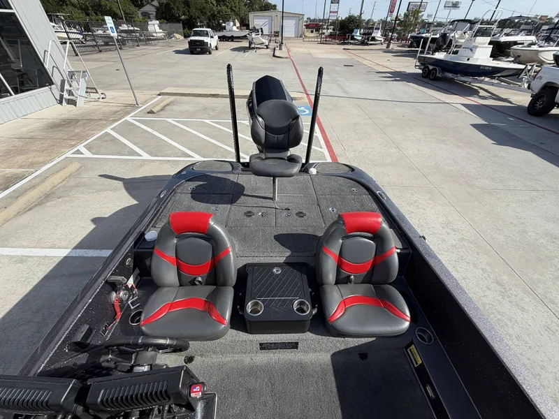 Slide: The Image of The image shows the cockpit of a 2018 Falcon F205 boat with gray and red seats. - 34