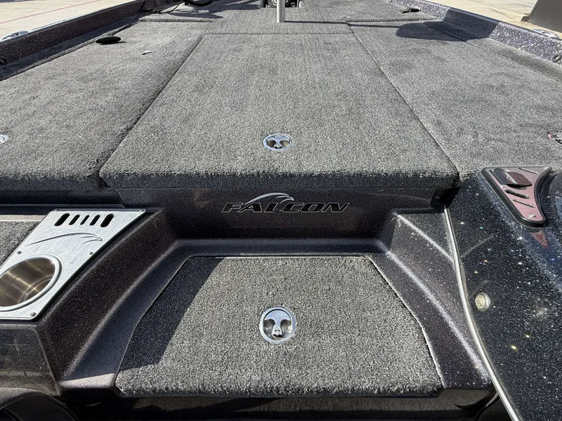 Slide: The Image of The image shows the deck of a 2018 Falcon F205 boat with gray carpeting. - 23