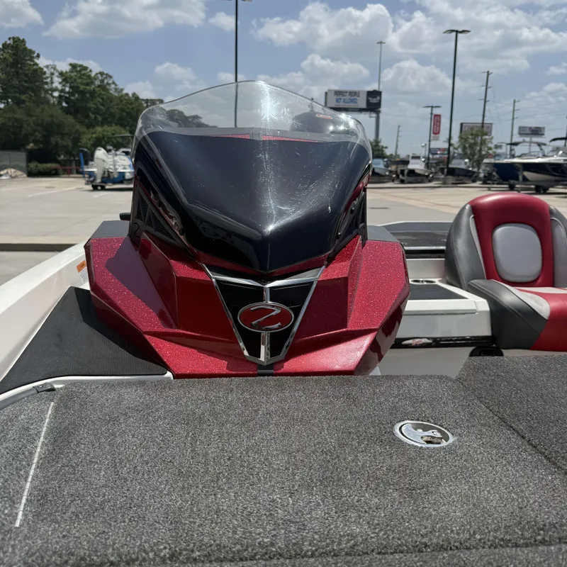 Slide: The Image of A 2019 Ranger Z518 boat with a red and black cockpit, gray deck, and cushioned seats. - 17