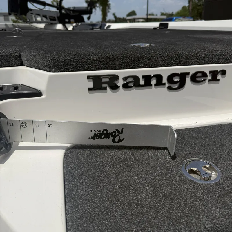 Slide: The Image of Close-up of a Ranger Z518 boat deck with a measuring scale and logo. - 24