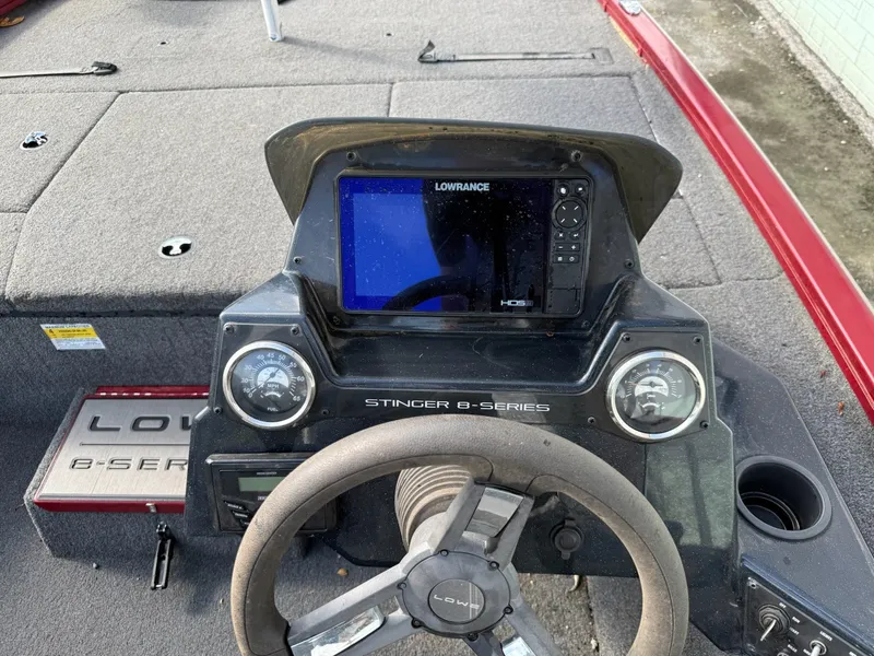 Slide: The Image of The image shows the cockpit of a 2023 Lowe Stinger 178 boat with a Lowrance fish finder. - 14