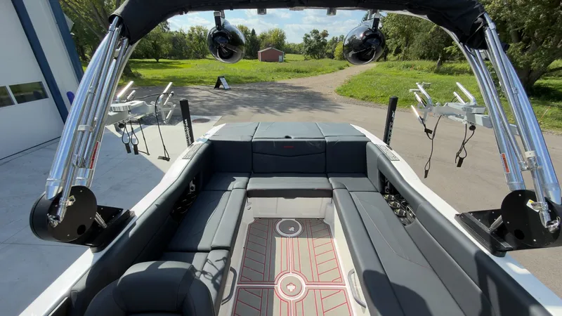 Slide: The Image of The image shows the interior of a 2021 MasterCraft NXT24 boat with gray seating and a modern design. - 8