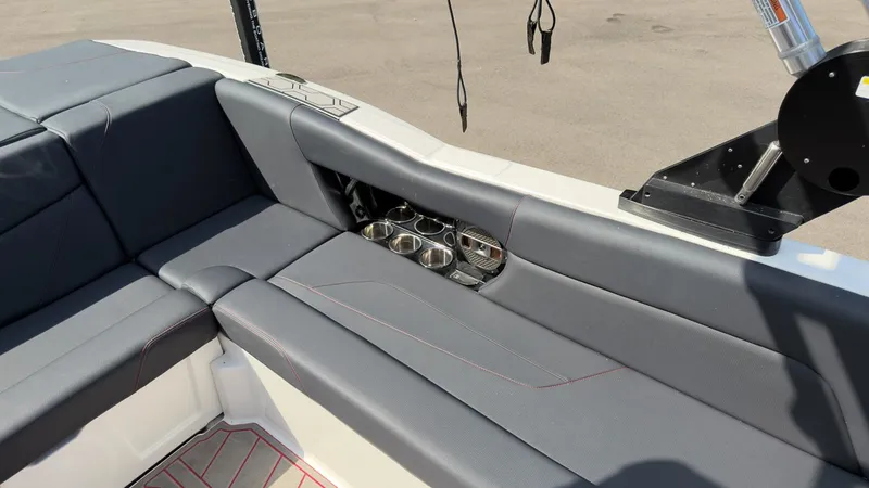 Slide: The Image of The image shows the gray upholstery of a 2021 MasterCraft NXT24 with cup holders. - 9