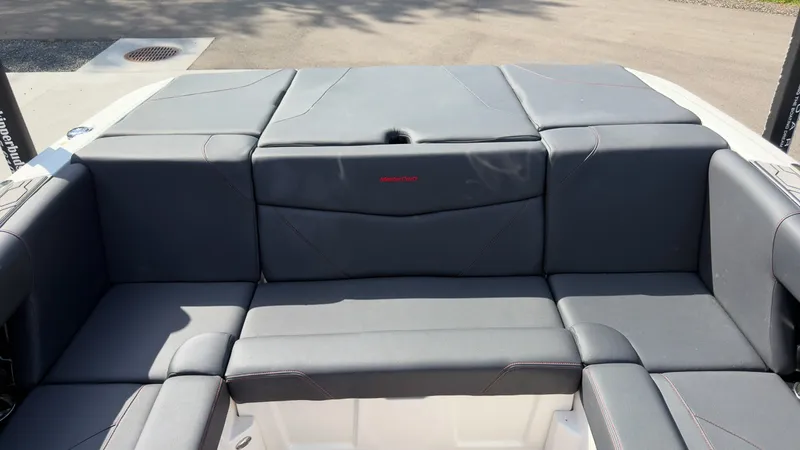 Slide: The Image of The image shows the rear seating of a 2021 MasterCraft NXT24 boat with gray upholstery. - 10