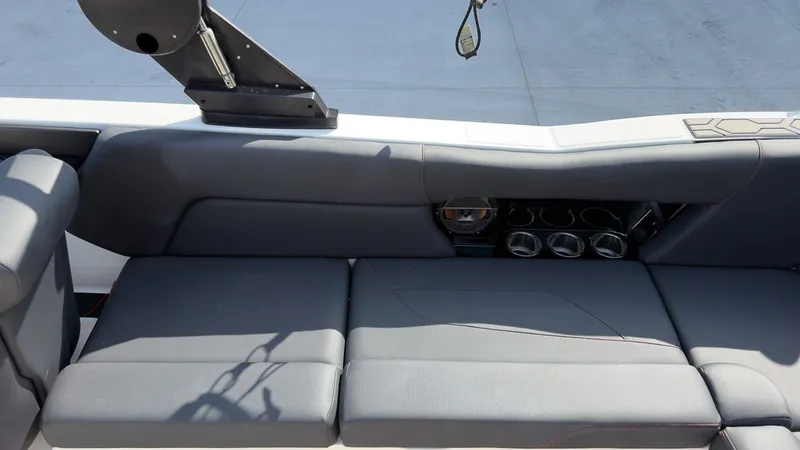 Slide: The Image of The image shows the gray upholstery of a 2021 MasterCraft NXT24 with cup holders. - 11