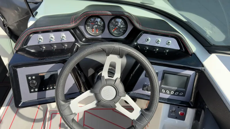 Slide: The Image of The dashboard of a 2021 MasterCraft NXT24 with steering wheel, gauges, and controls. - 7