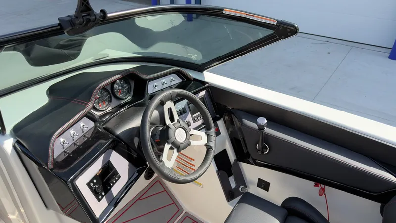 Slide: The Image of The image shows the cockpit of a 2021 MasterCraft NXT24 with a modern steering wheel and instruments. - 6