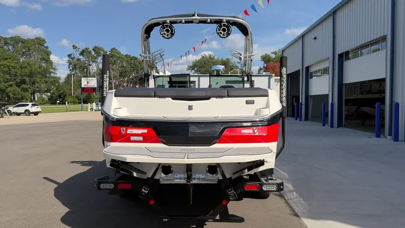 Slide: The Image of The image shows the rear of a 2021 MasterCraft NXT24 boat parked in front of a building. - 4