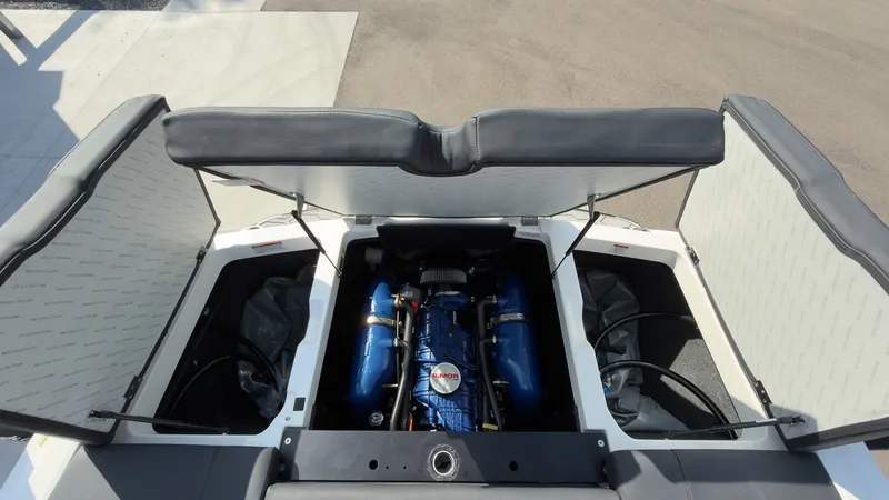 Slide: The Image of The engine compartment of a 2021 MasterCraft NXT24 with a blue engine and open covers. - 17