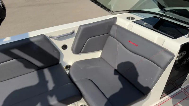Slide: The Image of The 2021 MasterCraft NXT24 features gray upholstery and a modern dashboard. - 18