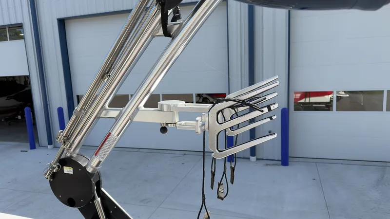 Slide: The Image of A 2021 MasterCraft NXT24 with a sleek wakeboard tower in front of a warehouse. - 12